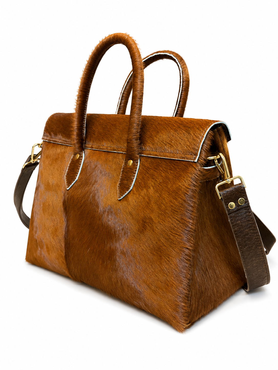 A brown cowhide handbag with dual top handles and a detachable shoulder strap, photographed on a clean white background.