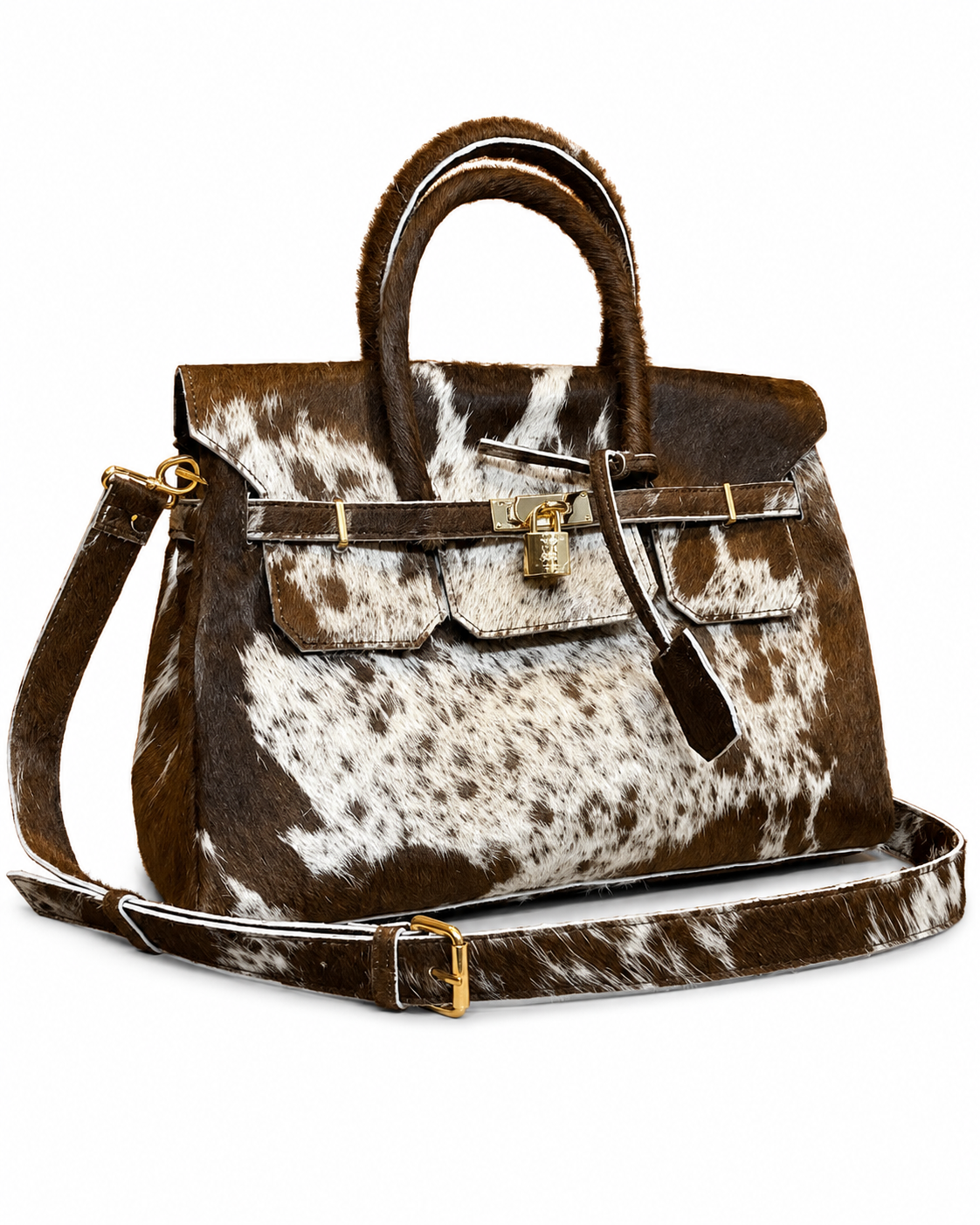 A structured handbag made from brown and white cowhide, featuring dual top handles, a front flap with a padlock closure, and a matching wide shoulder strap, photographed on a plain white background.